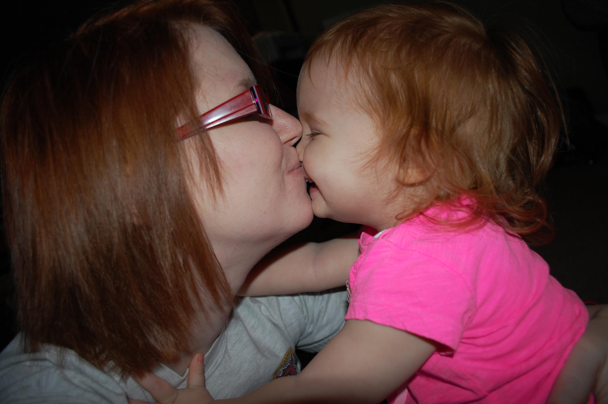 Image of woman kissing her toddler